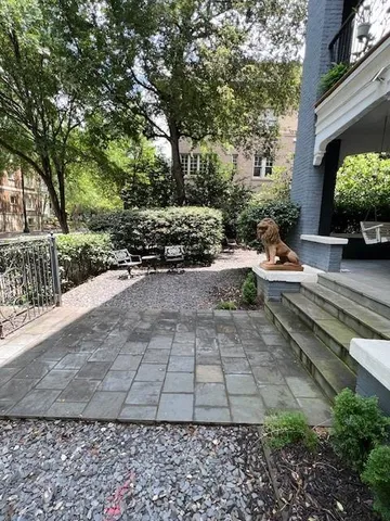 a view of a house with backyard and sitting area