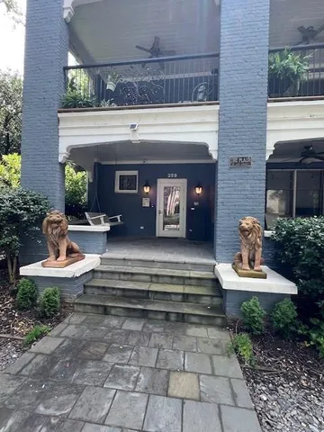a street sign on a tree next to a road