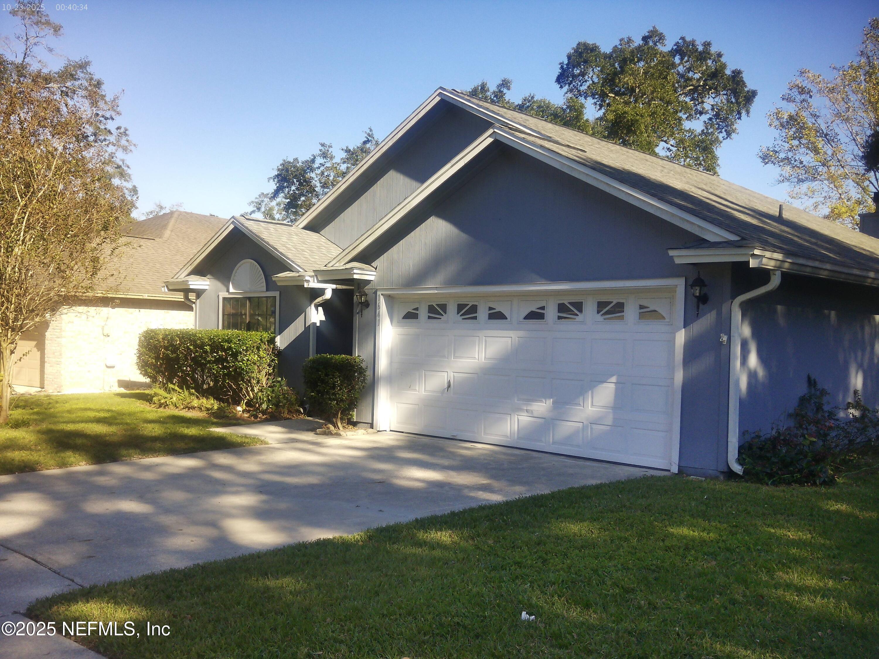 a backyard of a house with lots of green space and outdoor seating
