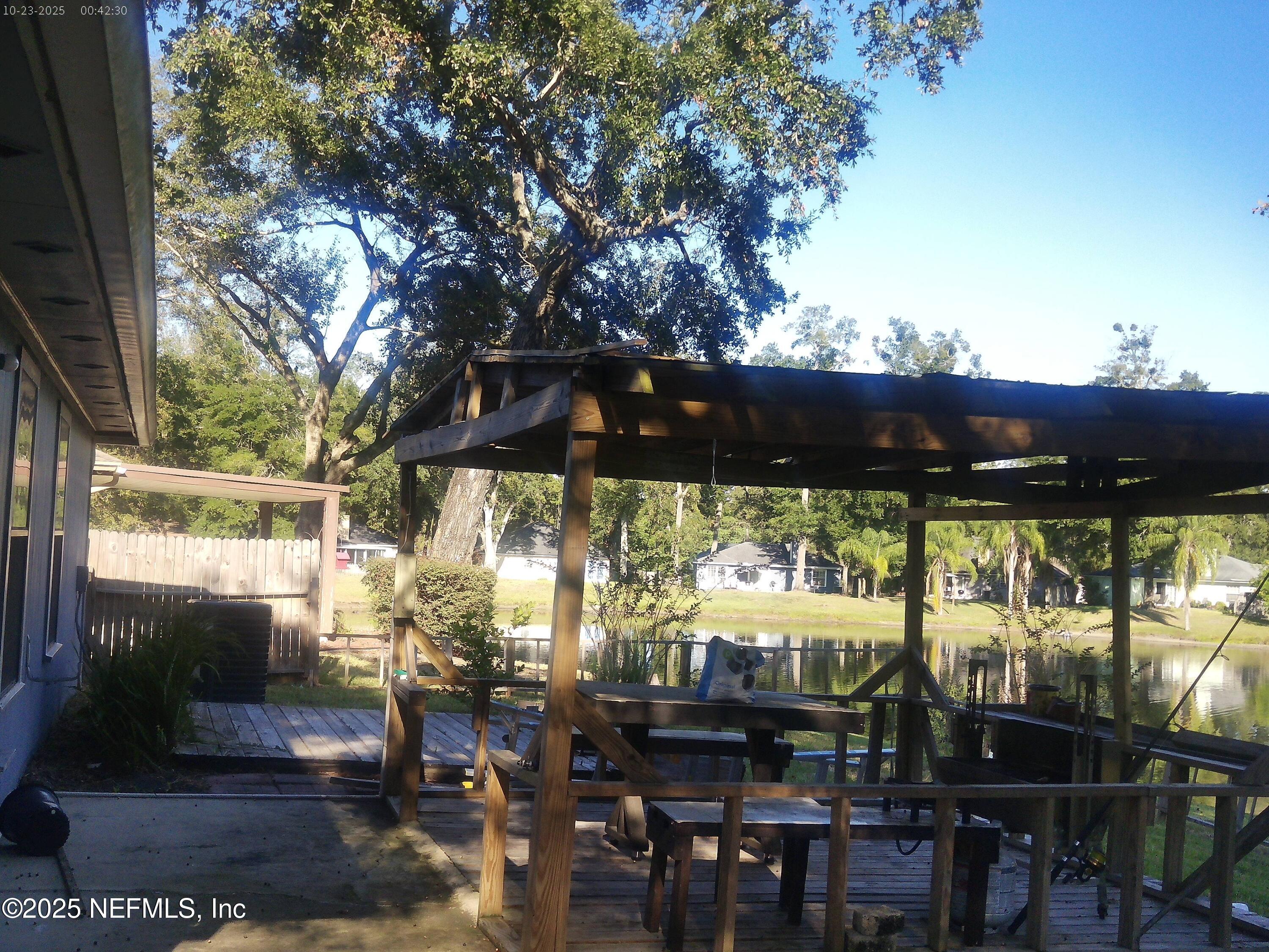 1641 Spring Oaks Lane Jacksonville, FL 32221 - Photo 12 of 24 a view of a patio with table and chairs under an umbrella