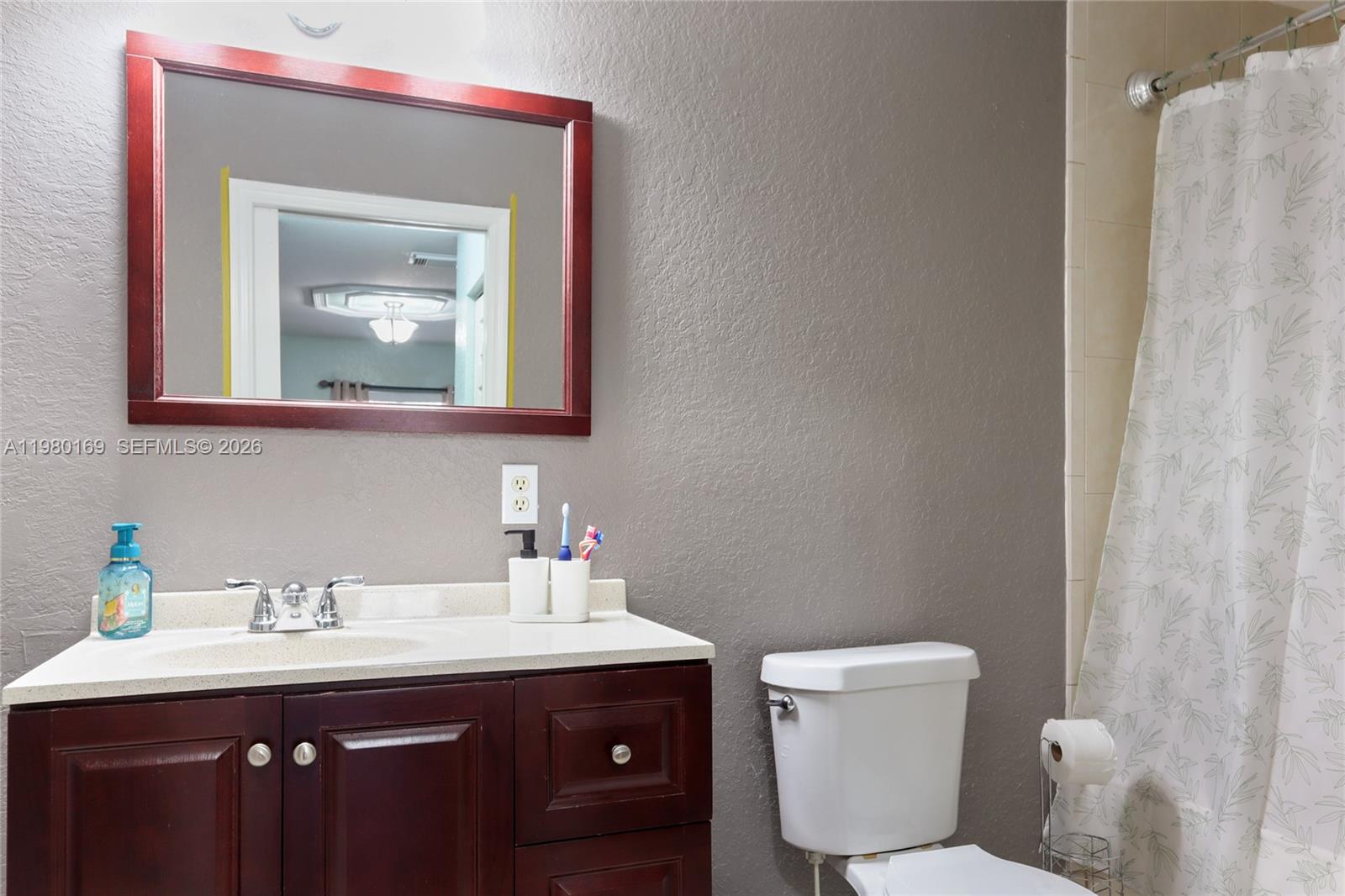 11397 Southwest 185th Terrace Miami, FL 33157 - Photo 13 of 15 a bathroom with a toilet sink and mirror