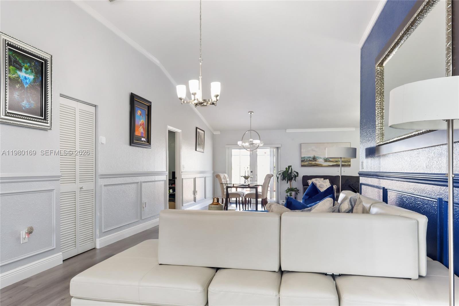 11397 Southwest 185th Terrace Miami, FL 33157 - Photo 3 of 15 a living room with furniture and a chandelier