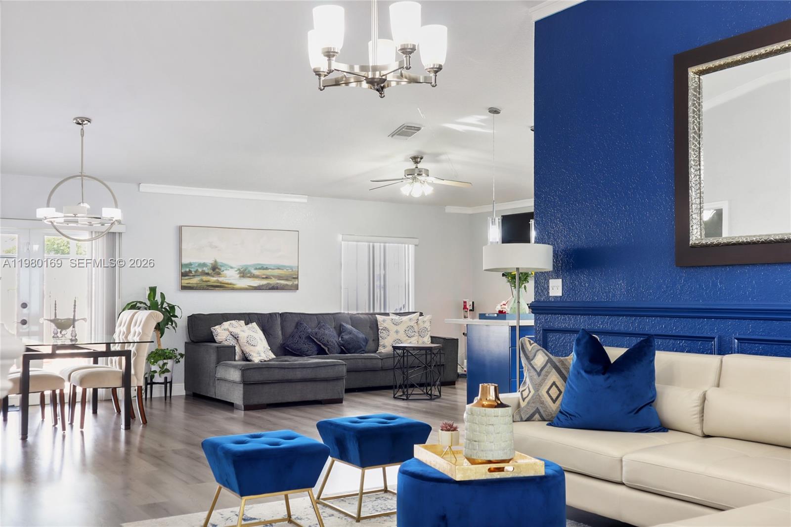 11397 Southwest 185th Terrace Miami, FL 33157 - Photo 4 of 15 a living room with furniture and a chandelier