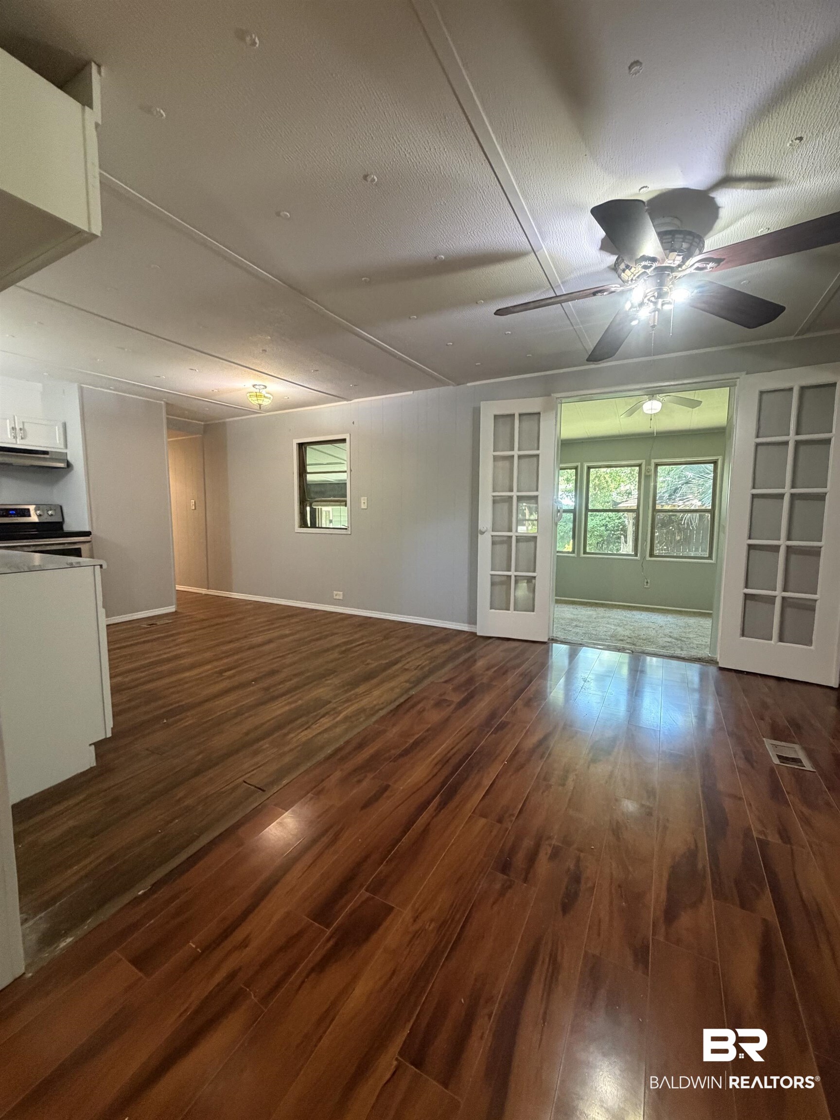 1354 Caney Loop Lillian, AL 36549 - Photo 7 of 45 Expansive wood-finish flooring throughout the main living area