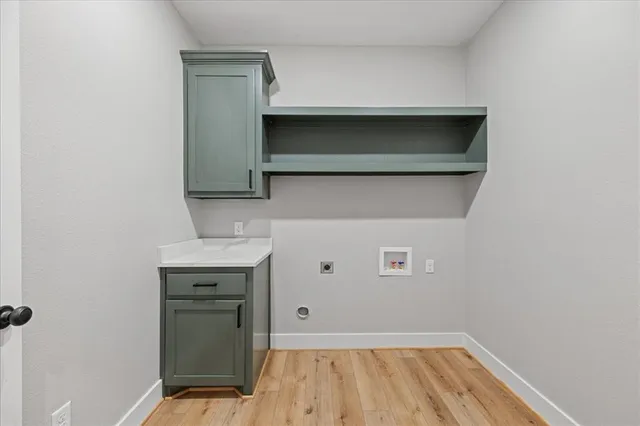 an empty room with chandelier fan and windows