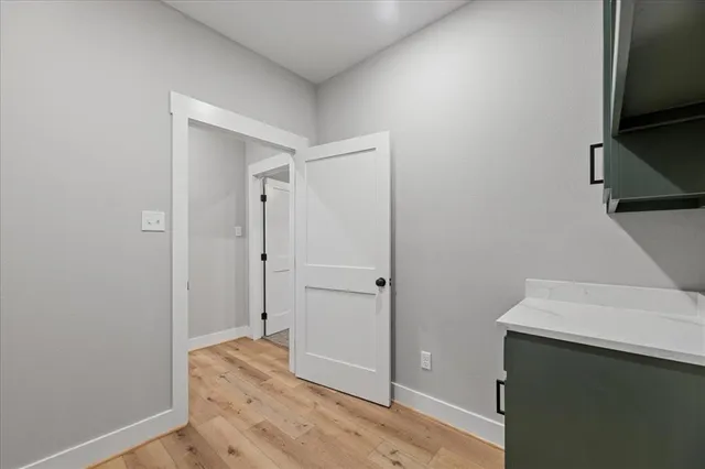 an empty room with fan and windows