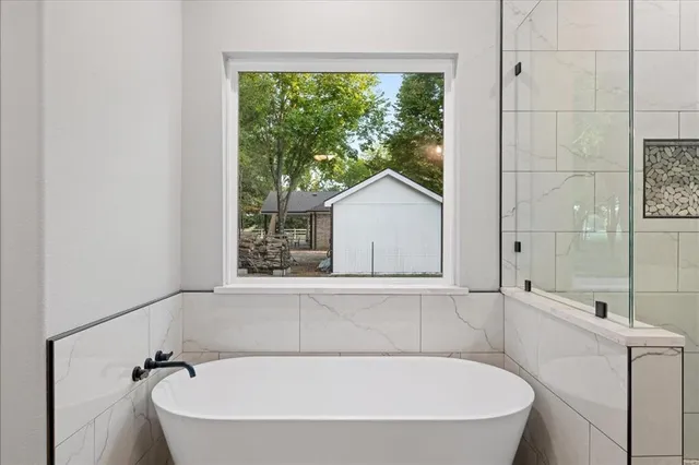 a bathroom with a sink vanity granite tub and shower