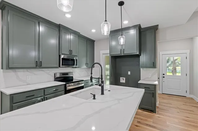 a kitchen with a stove and a microwave