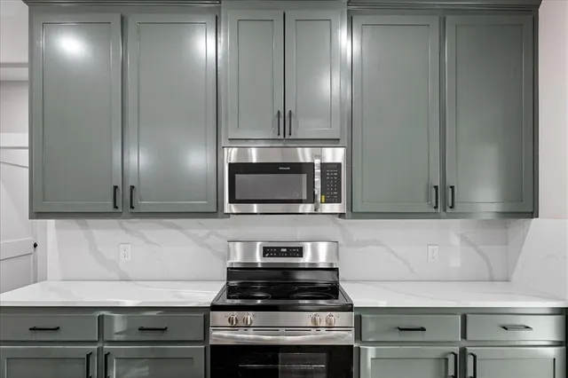 a view of a kitchen with a sink stainless steel appliances and cabinets