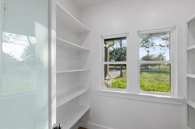 a bathroom with a walk in closet and a shower