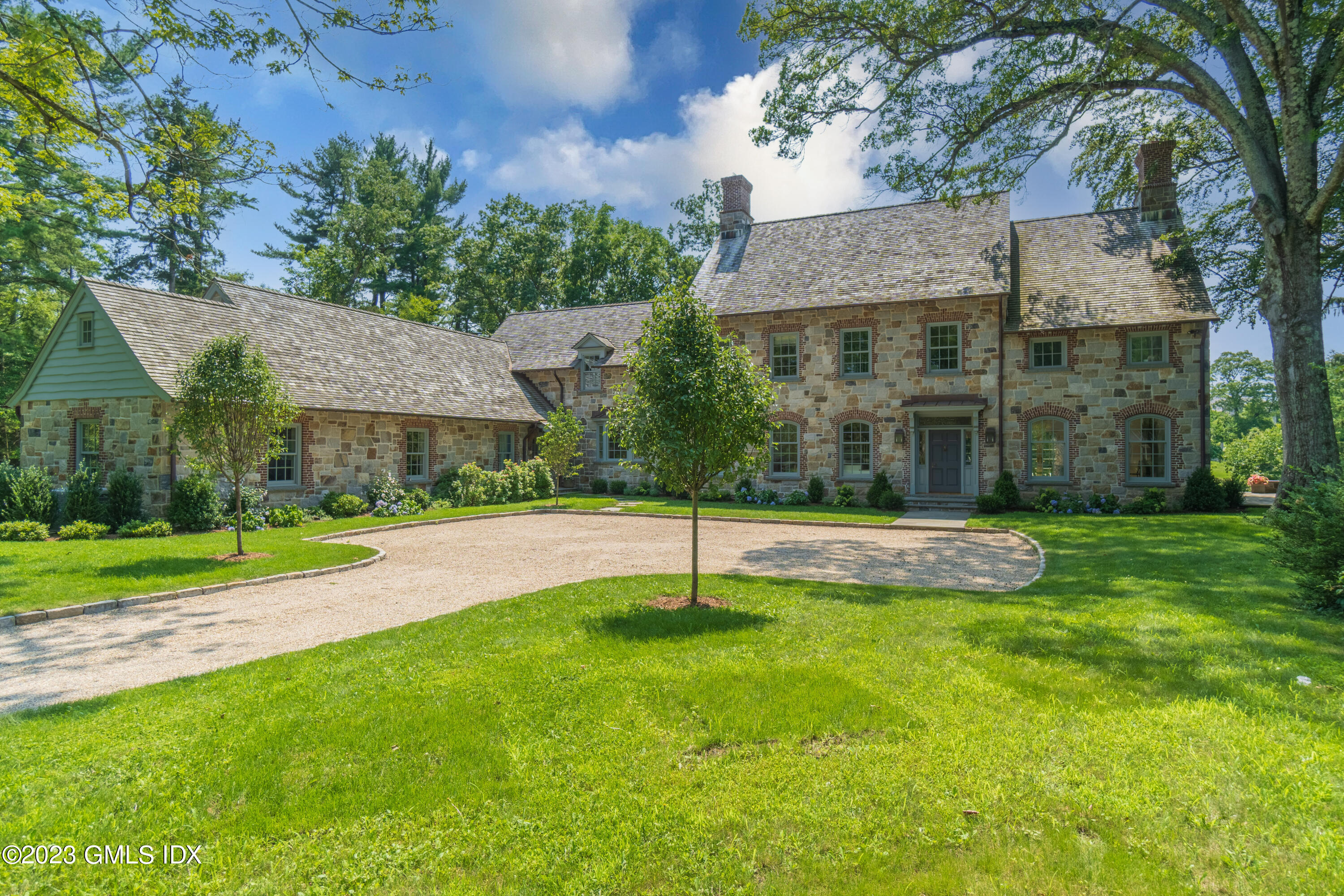 a view of a house with a yard and tree
