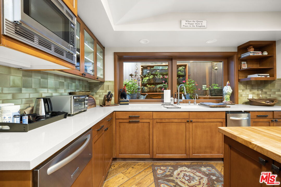 2618 Mandeville Canyon Road Los Angeles, CA 90049 - Photo 13 of 45 a kitchen with stainless steel appliances granite countertop a sink and cabinets
