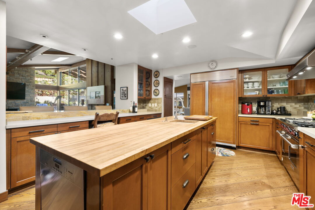 2618 Mandeville Canyon Road Los Angeles, CA 90049 - Photo 14 of 45 a kitchen with stainless steel appliances granite countertop a kitchen island a stove and a sink