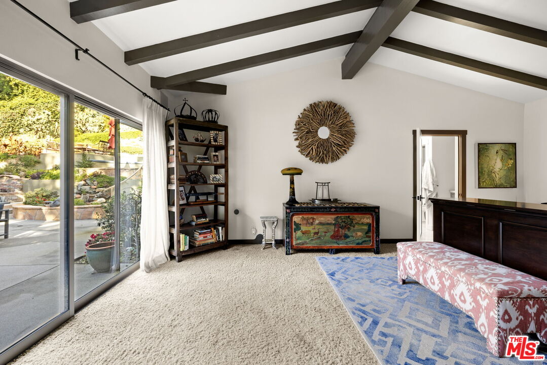 2618 Mandeville Canyon Road Los Angeles, CA 90049 - Photo 15 of 45 a bedroom with furniture and a flat screen tv
