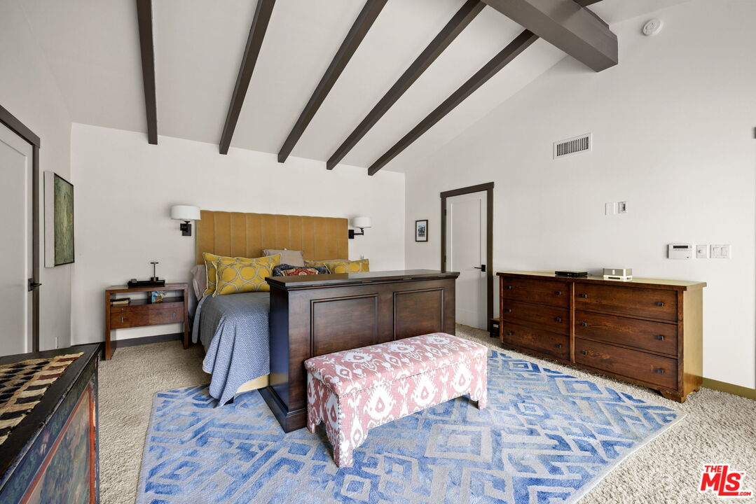 2618 Mandeville Canyon Road Los Angeles, CA 90049 - Photo 16 of 45 a bedroom with furniture and wooden floor