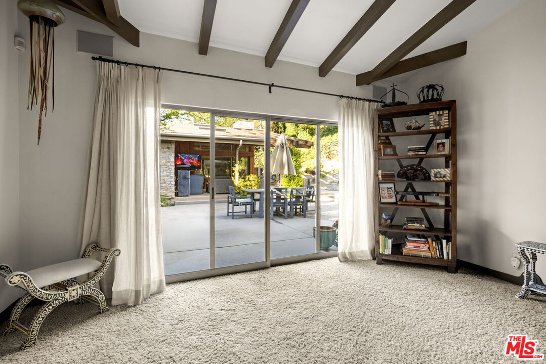 2618 Mandeville Canyon Road Los Angeles, CA 90049 - Photo 17 of 45 a view of a hallway with table and chairs