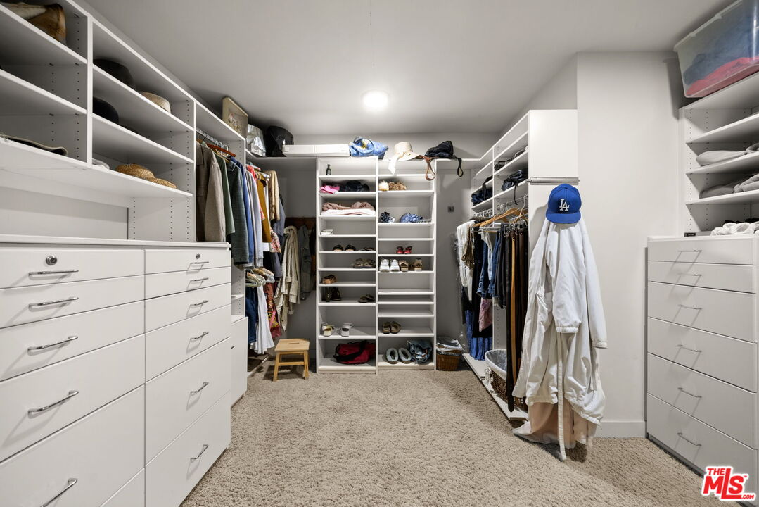 2618 Mandeville Canyon Road Los Angeles, CA 90049 - Photo 18 of 45 a view of walk in closet with clothes