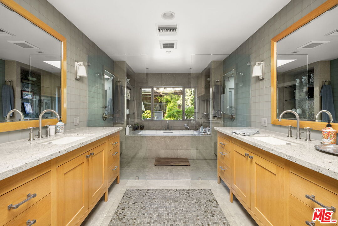 2618 Mandeville Canyon Road Los Angeles, CA 90049 - Photo 20 of 45 a large white kitchen with a large window