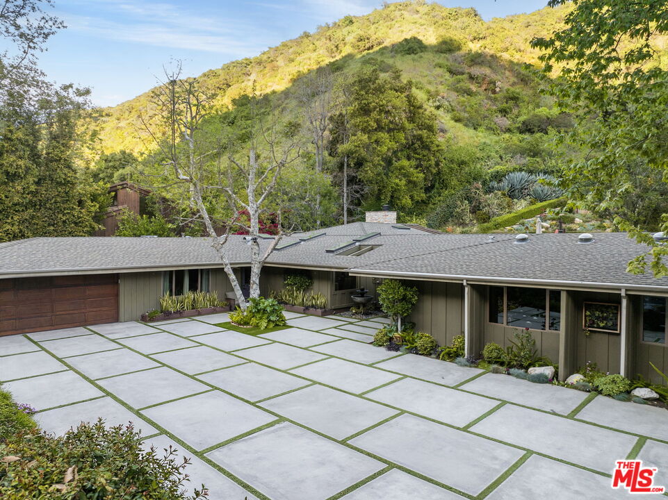 2618 Mandeville Canyon Road Los Angeles, CA 90049 - Photo 2 of 45 a house with trees in the background