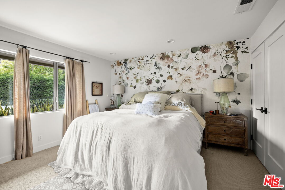 2618 Mandeville Canyon Road Los Angeles, CA 90049 - Photo 22 of 45 a bedroom with a bed and a window