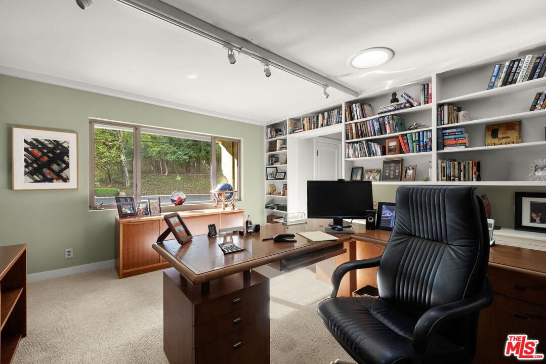 2618 Mandeville Canyon Road Los Angeles, CA 90049 - Photo 26 of 45 a work room with furniture and a bookshelf