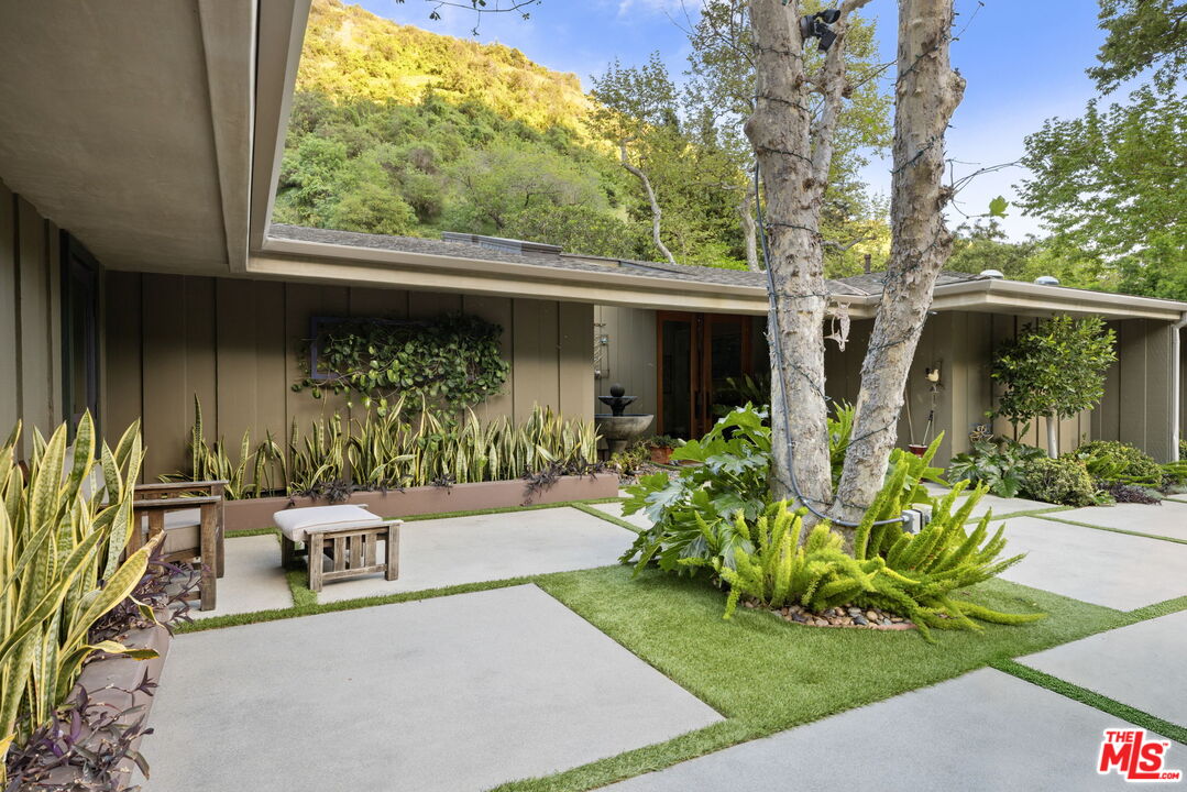 2618 Mandeville Canyon Road Los Angeles, CA 90049 - Photo 3 of 45 a view of a house with backyard and sitting area