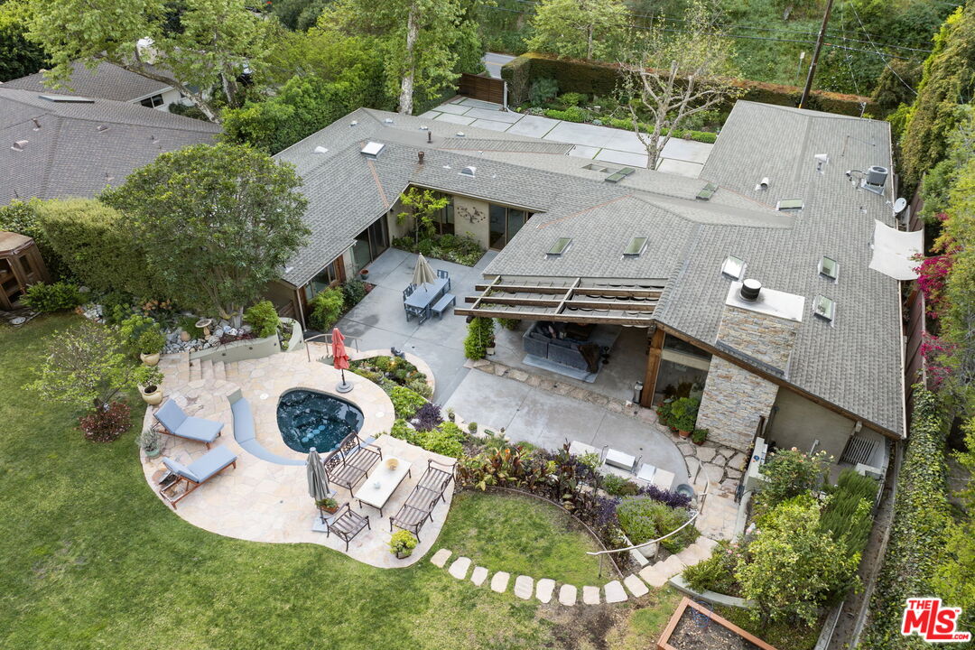 2618 Mandeville Canyon Road Los Angeles, CA 90049 - Photo 45 of 45 an aerial view of a house with swimming pool and a yard