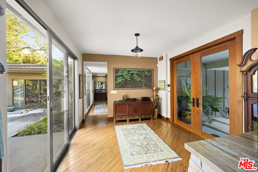 2618 Mandeville Canyon Road Los Angeles, CA 90049 - Photo 5 of 45 a living room with a couch and a table