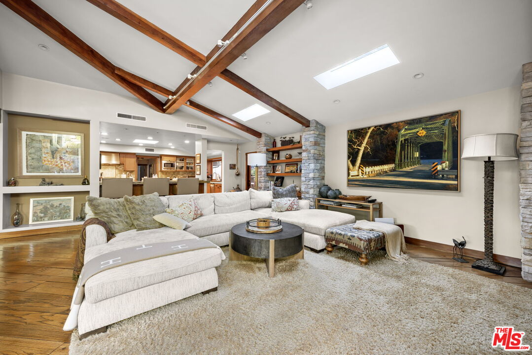 2618 Mandeville Canyon Road Los Angeles, CA 90049 - Photo 9 of 45 a living room with furniture and a flat screen tv