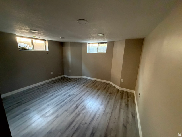 541 Mingo View Avenue Sandy, UT 84070 - Photo 9 of 16 Spacious room featuring wood-finish flooring, recessed lighting, and neutral wall tones
