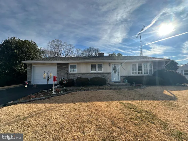 a backyard of a house with large trees