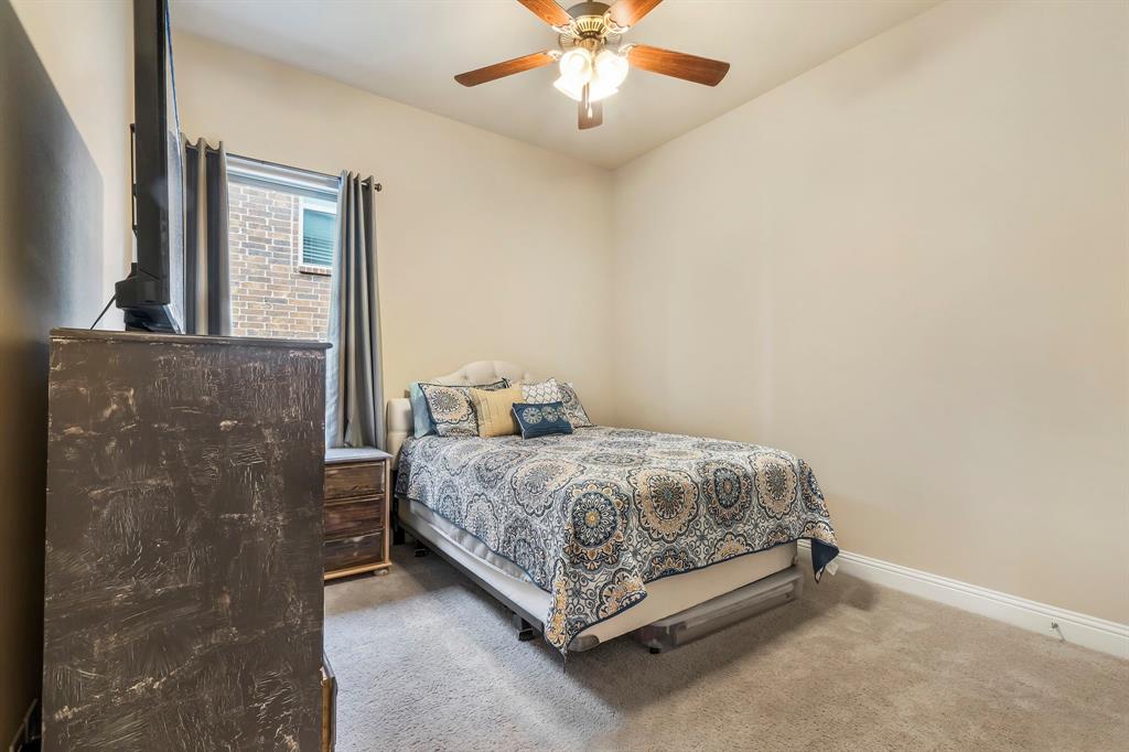 3610 Bastrop Street Melissa, TX 75454 - Photo 20 of 23 a spacious bedroom with a bed and a chandelier