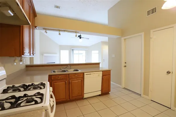 a kitchen with a stove a sink and a refrigerator