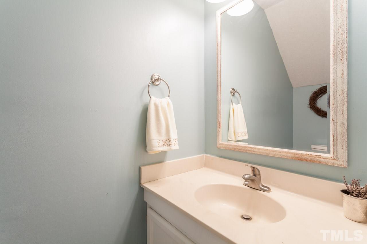 5754 Pool Side Drive Raleigh, NC 27612 - Photo 13 of 23 a bathroom with a sink and a mirror