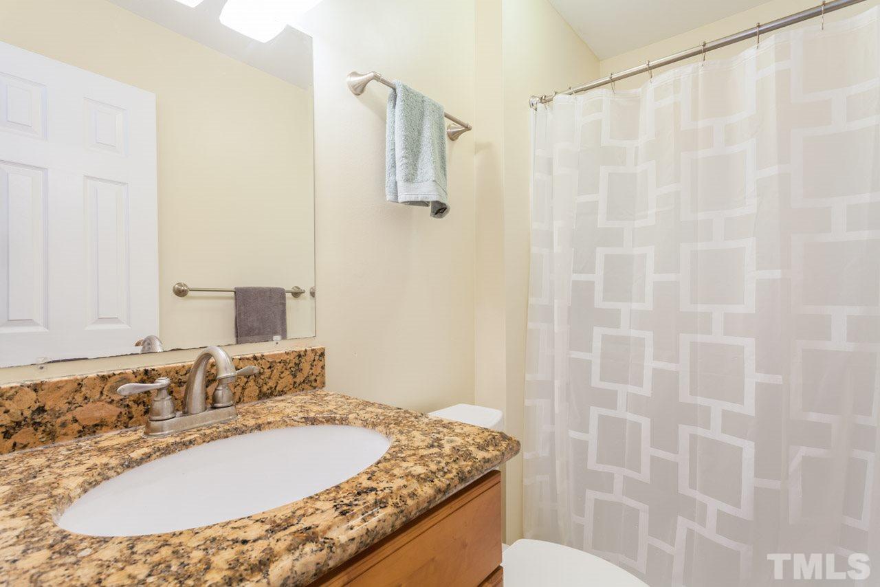 5754 Pool Side Drive Raleigh, NC 27612 - Photo 16 of 23 a bathroom with a granite countertop sink and a mirror