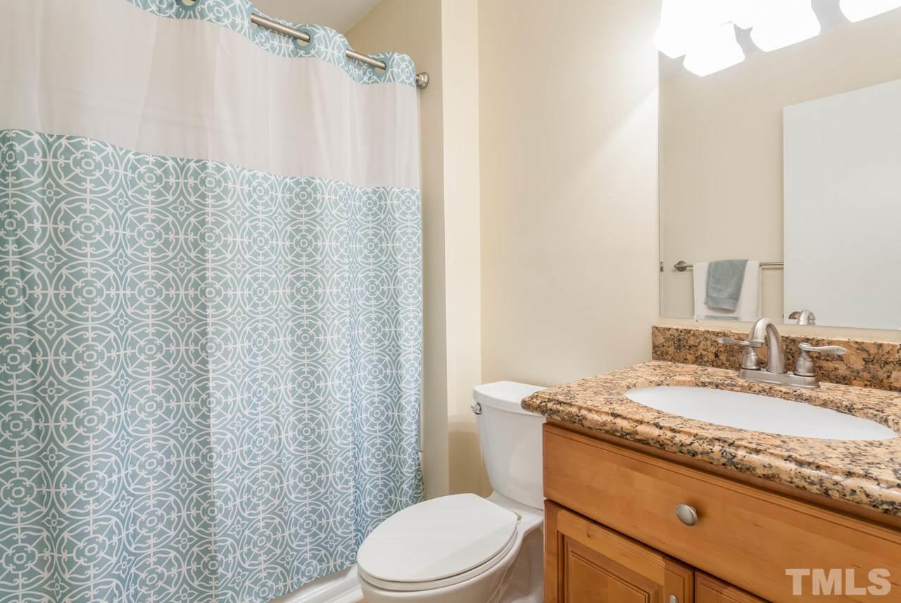 5754 Pool Side Drive Raleigh, NC 27612 - Photo 19 of 23 a bathroom with a granite countertop sink toilet and shower