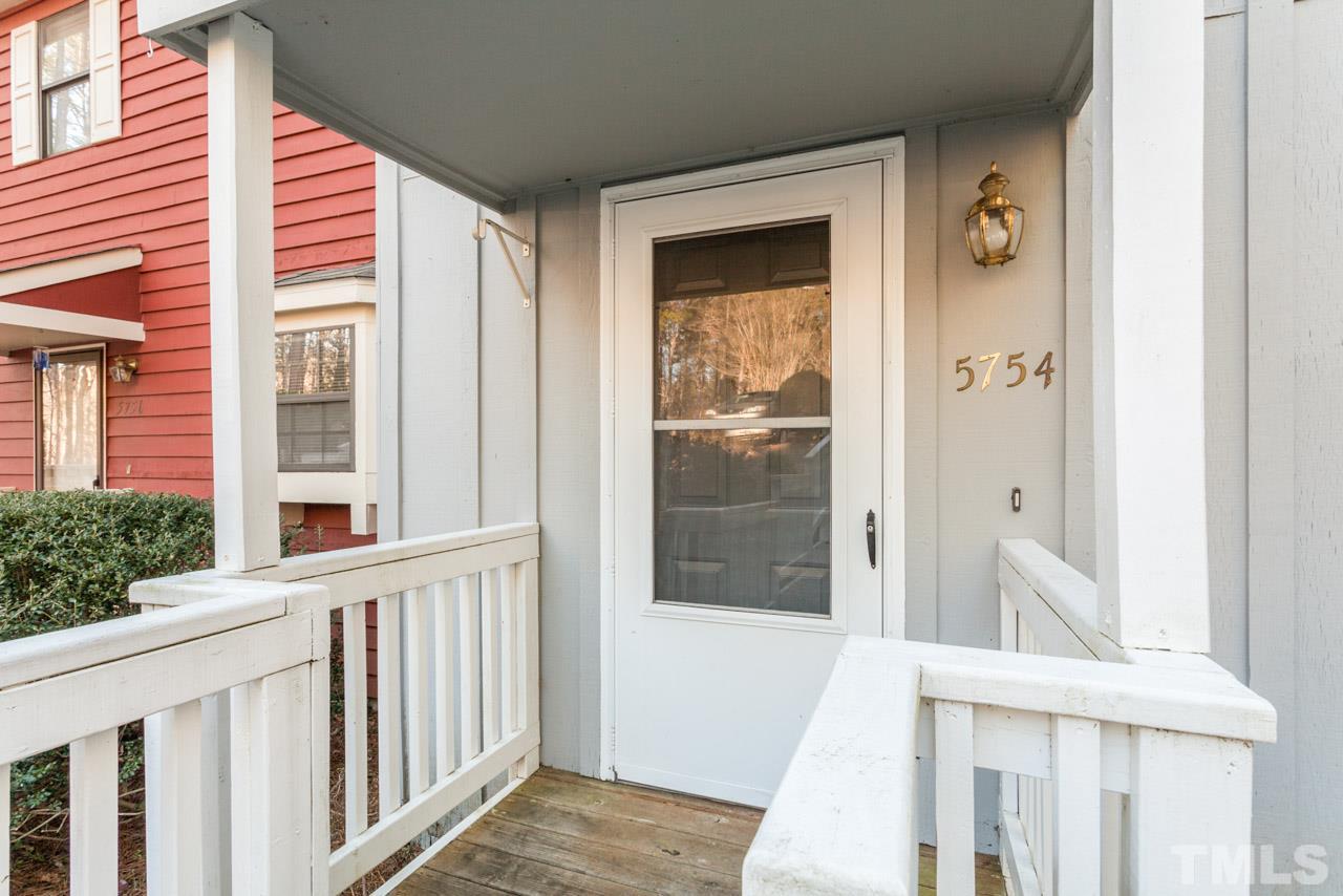 5754 Pool Side Drive Raleigh, NC 27612 - Photo 3 of 23 a view of a porch with a table and chair