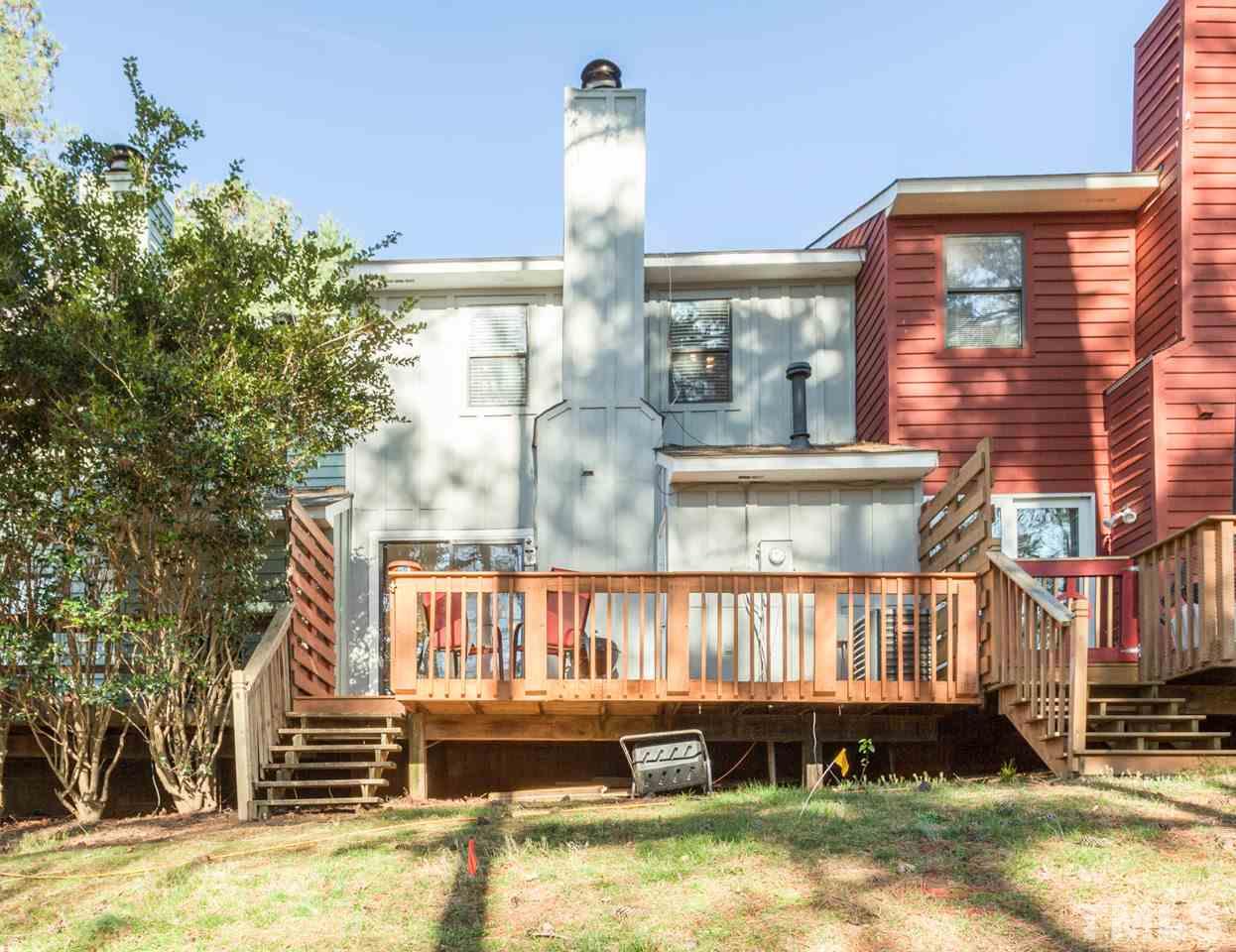 5754 Pool Side Drive Raleigh, NC 27612 - Photo 23 of 23 a front view of a house with a yard fountain and a tree