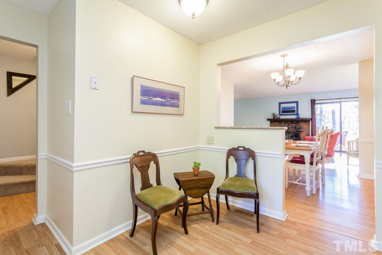 5754 Pool Side Drive Raleigh, NC 27612 - Photo 7 of 23 a view of a dining room with furniture and wooden floor