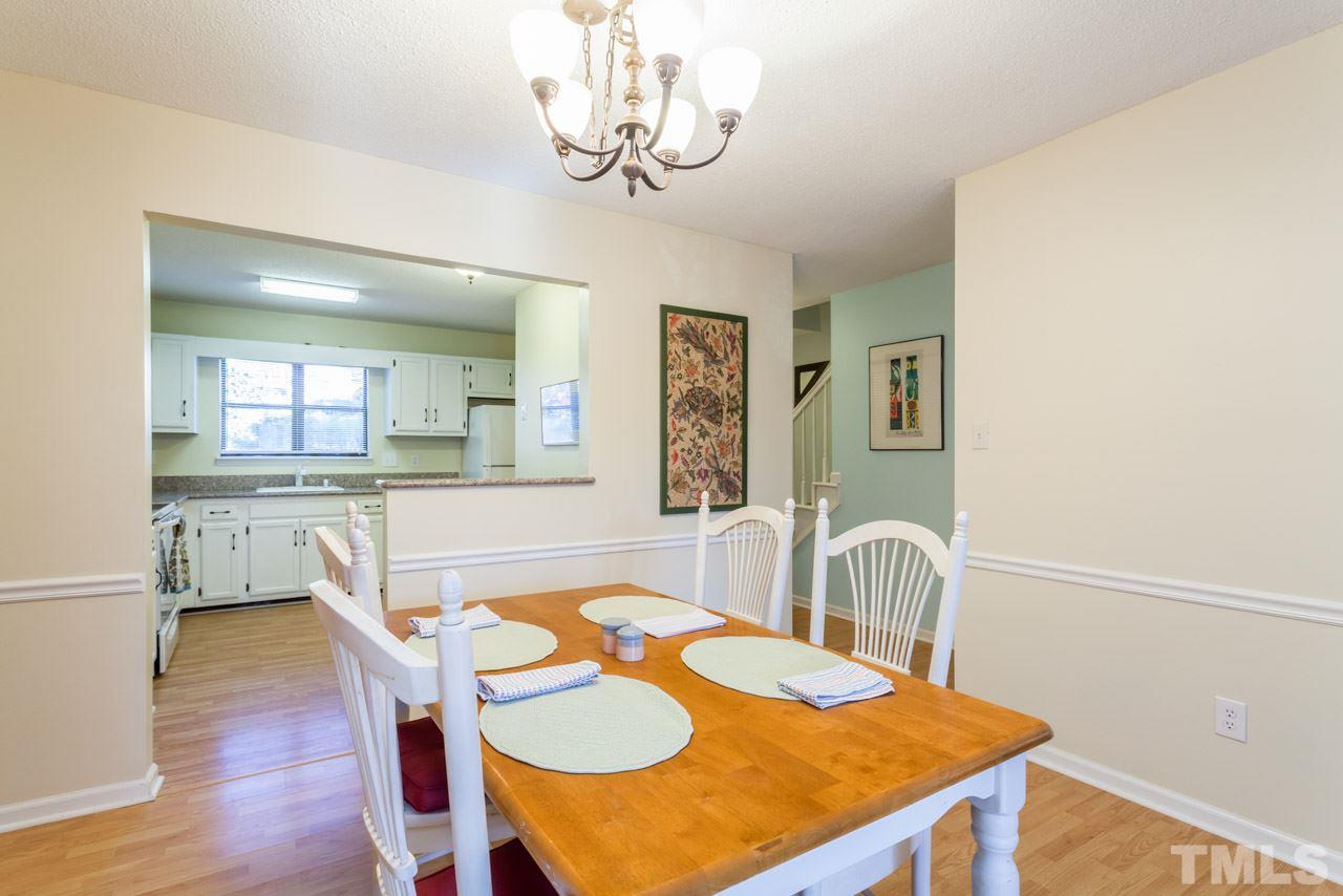 5754 Pool Side Drive Raleigh, NC 27612 - Photo 8 of 23 a view of a dining room with furniture and wooden floor