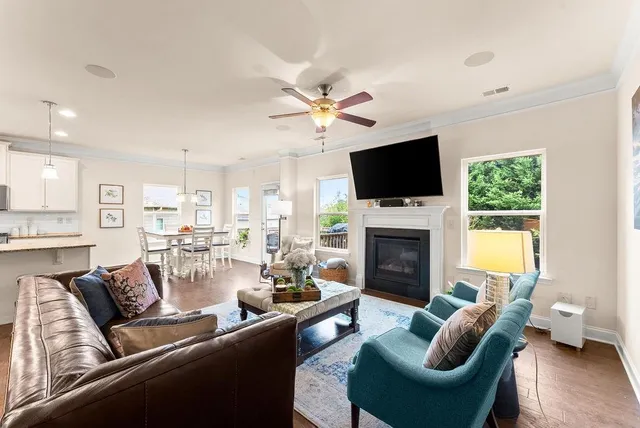 a living room with furniture a fireplace and a flat screen tv