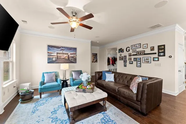 a living room with furniture and a flat screen tv