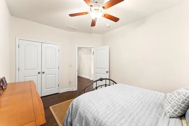 a bedroom with a bed and a chandelier