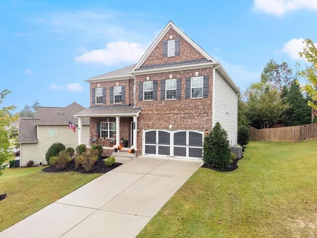 a front view of a house with a garden
