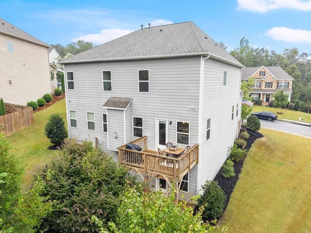 a view of a house with backyard and sitting area