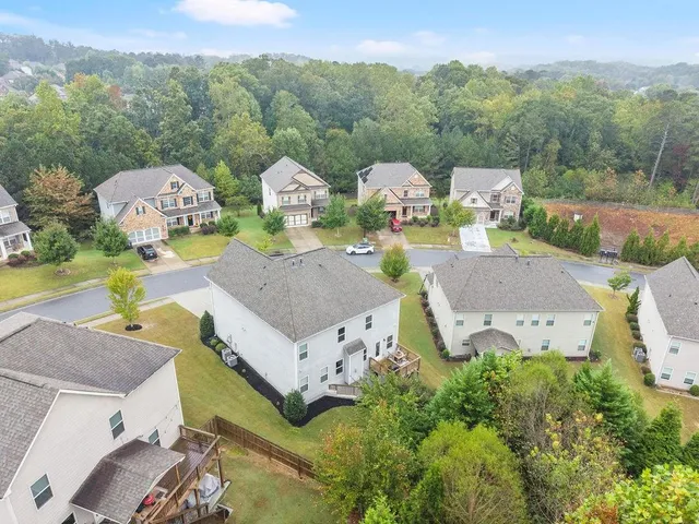 an aerial view of a house with garden space and street view
