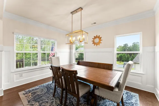 a view of a dining room with furniture window and wooden floor