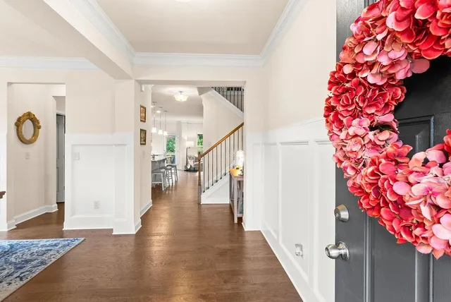 a view of entryway and hall with wooden floor