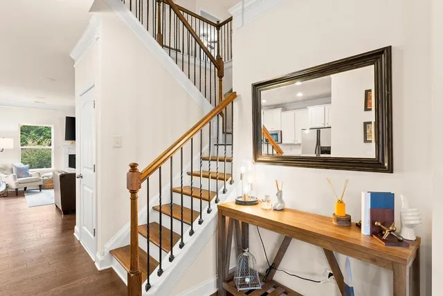 a view of entryway and hall with wooden floor