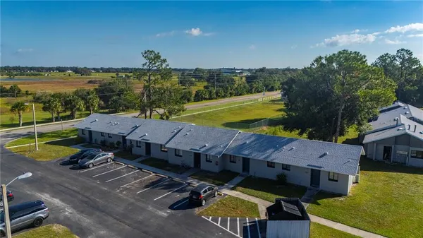 an aerial view of residential houses with outdoor space and swimming pool